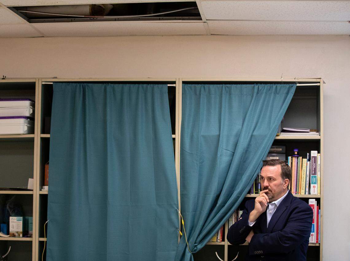 Douglas Congdon, program executive for facilities design and construction, stands beneath ceiling damage from leaks in a classroom at Brentwood Elementary School on Wednesday, Oct. 12, 2022, in Raleigh, N.C. Brentwood Elementary is one of seven schools that would undergo renovations in a $530.7 million bond referendum on the Nov. 8 ballot.