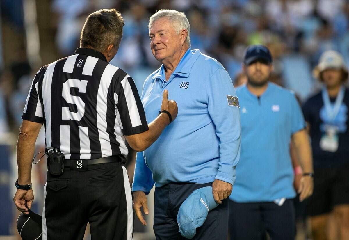 North Carolina coach Mack Brown talks with Side Judge George Lotus prior to the Tar Heels season opener against Florida A&M on Saturday, August 27, 2022 at Kenan Stadium in Chapel Hill, N.C.