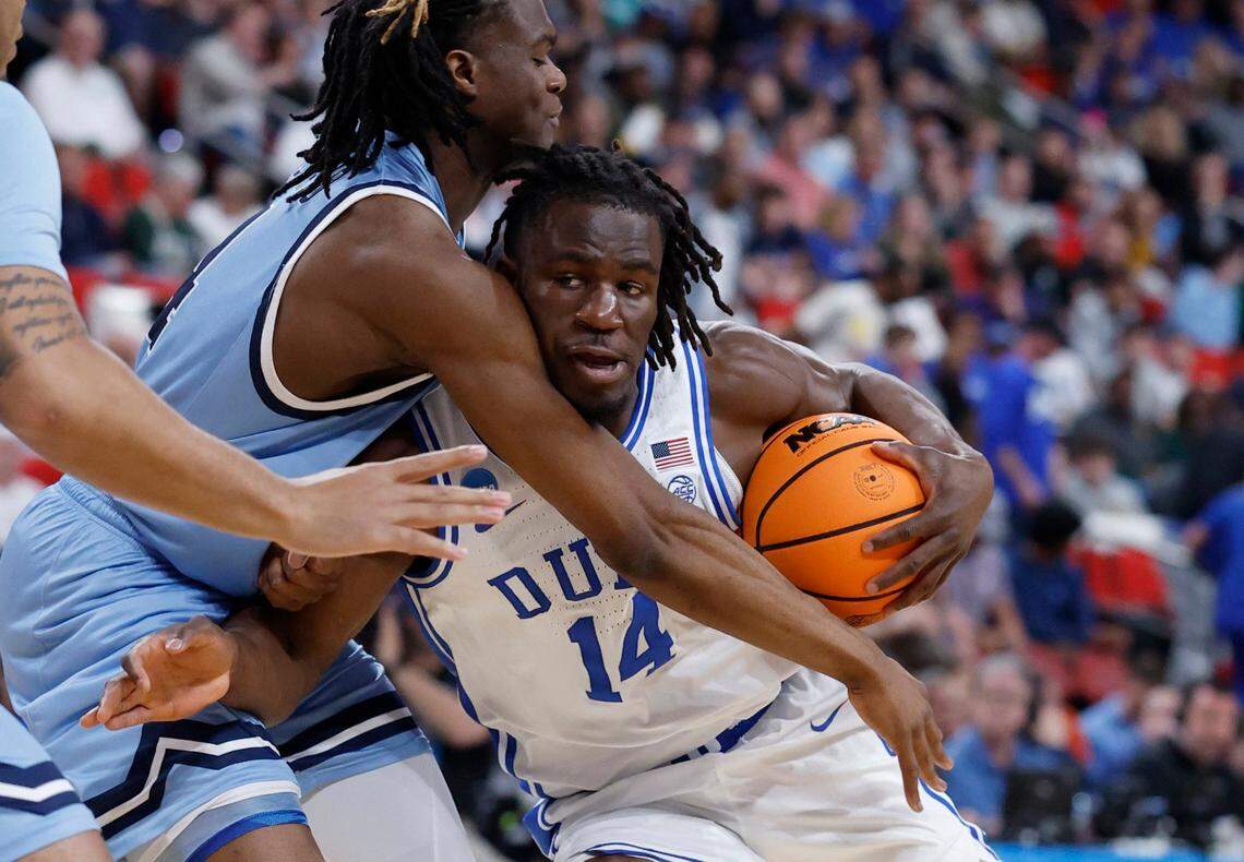 Duke’s Sion James (14) tries to drive around Mount St. Mary’s Jedy Cordilia (14) during the first half of Duke’s game against Mount St. Mary’s in the first round of the 2025 NCAA Men’s Basketball Tournament at the Lenovo Center in Raleigh, N.C., Friday, March 21, 2025.