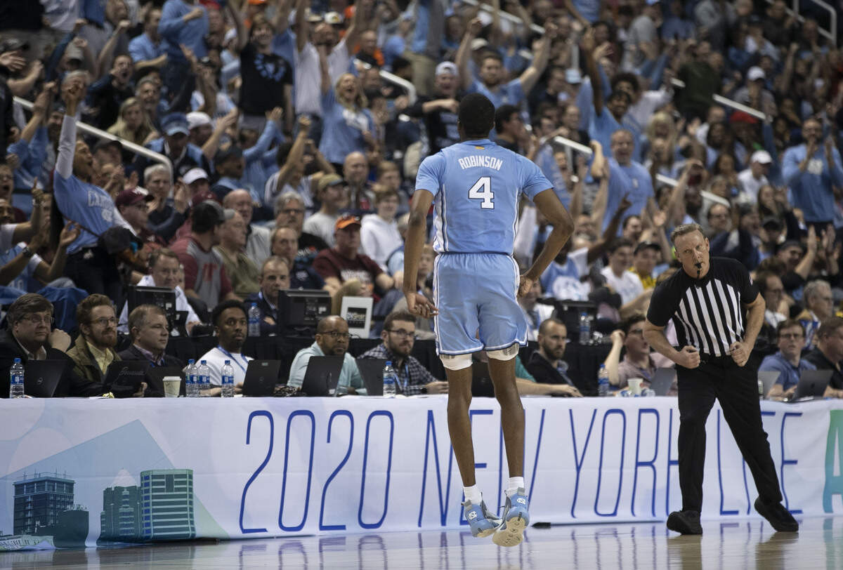 North Carolina’s Brandon Robinson (4) reacts after sinking a three-point shot over Virginia Tech’s Nahiem Alleyne (4) in the second half on Tuesday, March 10, 2020 during the first round of the ACC Tournament at the Greensboro Coliseum in Greensboro, N.C. Robinson scored 17 points, shooting 5 of 6 from the three point line. 