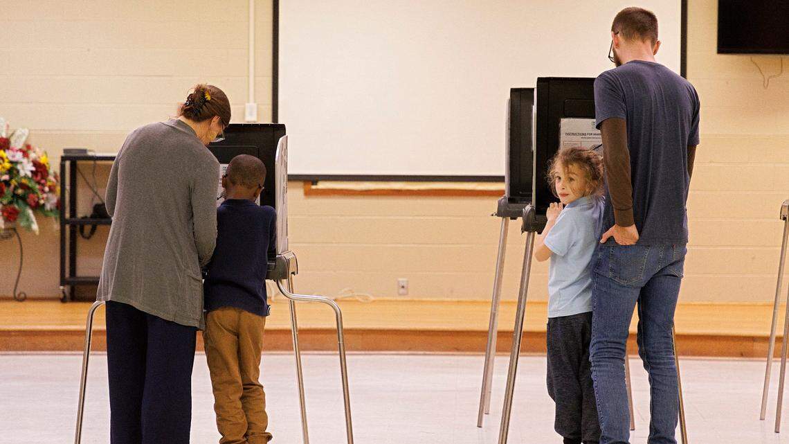 Laura Klein and Andrew Witkins vote with their children, Prince, 6, and Otis, 8, at White Rock Baptist Church on Tuesday, March 5, 2024, in Durham, N.C.