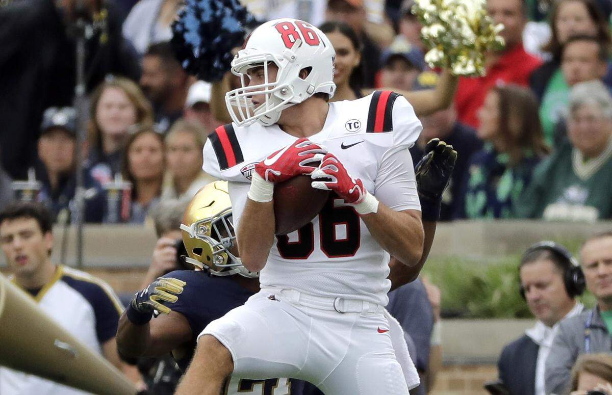 Ball State wide receiver Riley Miller (86) catches the ball against Notre Dame cornerback Julian Love during the first half of an NCAA college football game in South Bend, Ind., Saturday, Sept. 8, 2018.