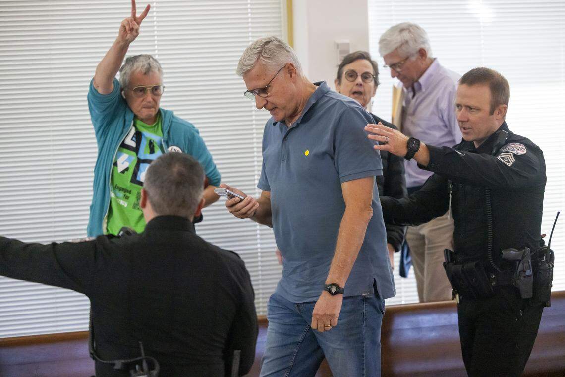 Demonstrators are removed from the gallery of the N.C. House as they loudly denounce Senate Bill 249, a bill to realign the North Carolina congressional districts, on Oct. 22, 2025, at the General Assembly in Raleigh. The bill passed 66-48.