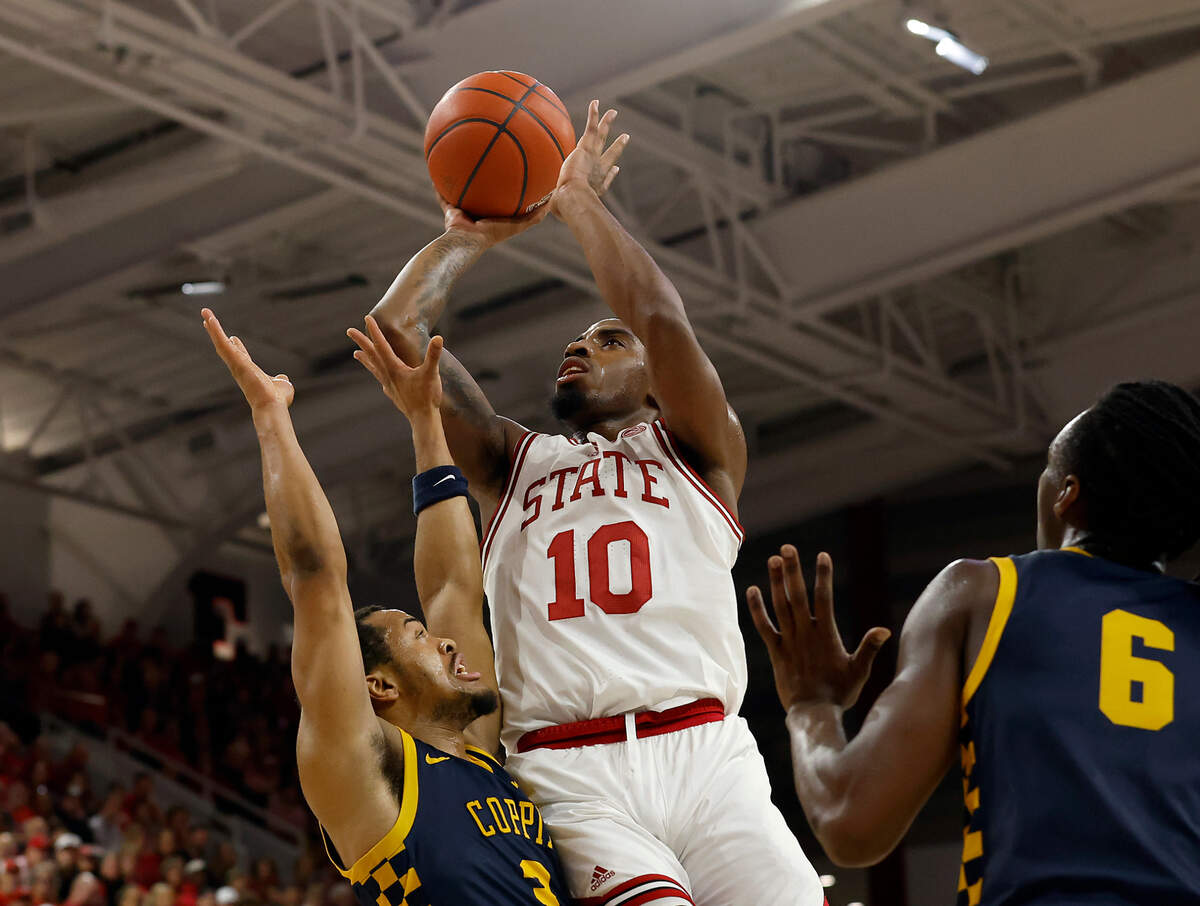 N.C. State’s Marcus Hill drives to the basket past Coppin State’s Cam’Ron Brown during the first half of the Wolfpack’s 66-56 win on Tuesday, Dec. 10, 2024, at Reynolds Coliseum in Raleigh, N.C.