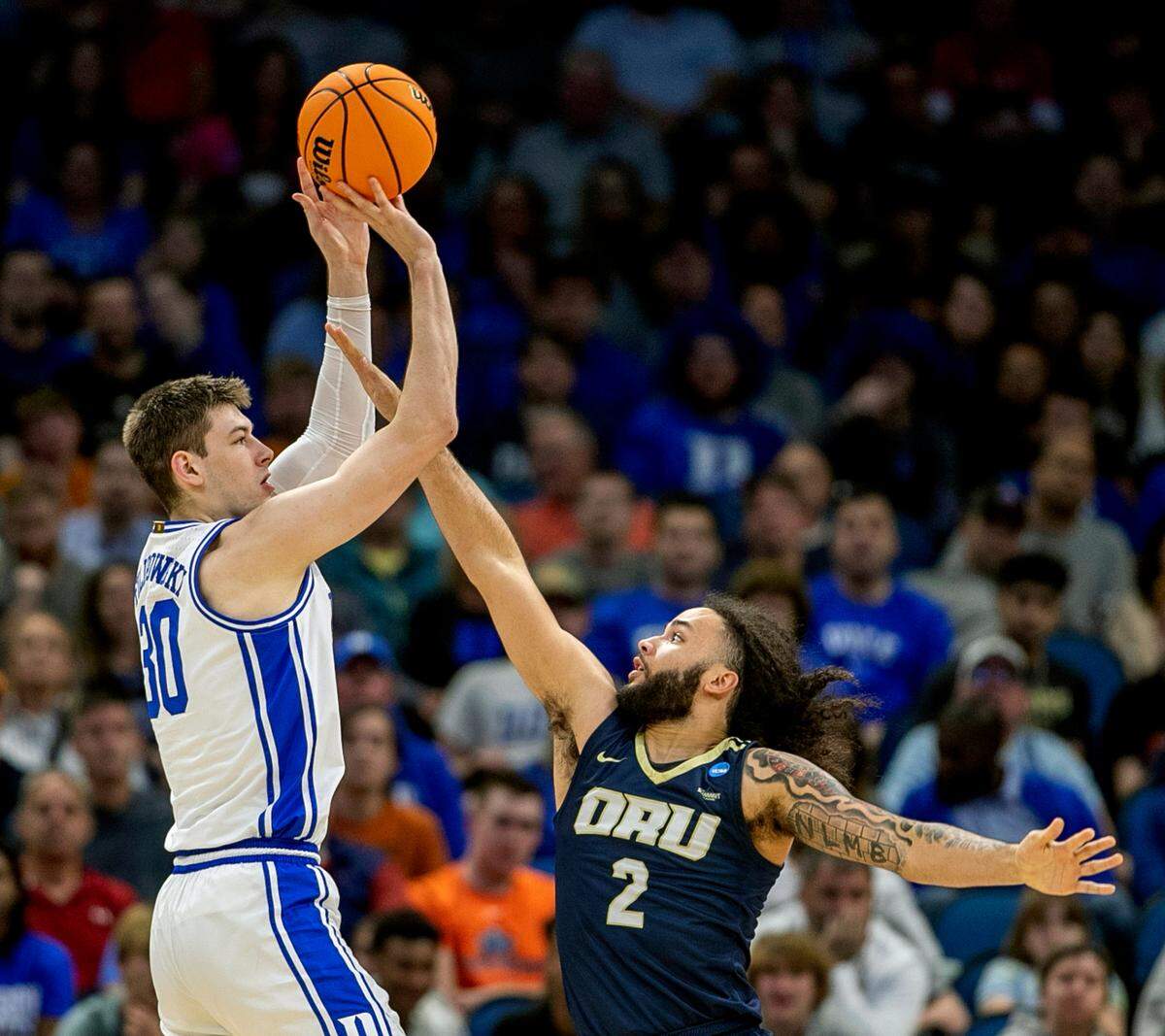 Duke’s Kyle Filipowski (30) puts up a shot against Oral Roberts’ Kareem Thompson (2) in the first half during the first round of the NCAA Tournament on Thursday, March 16, 2023 at the Amway Center in Orlando, Fla.