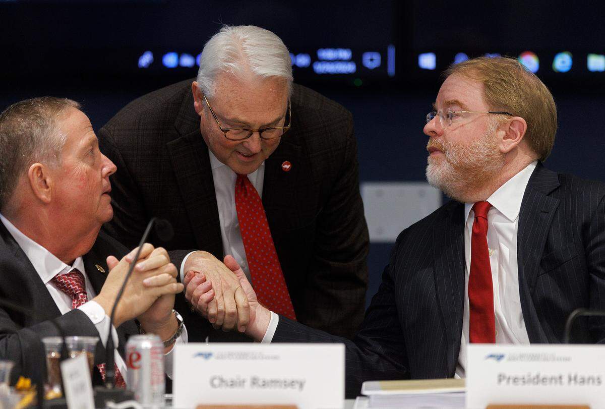 N.C. State Chancellor Randy Woodson shakes hands with UNC System President Peter Hans following a committee meeting on Wednesday, Jan. 24, 2024, in Raleigh, N.C.