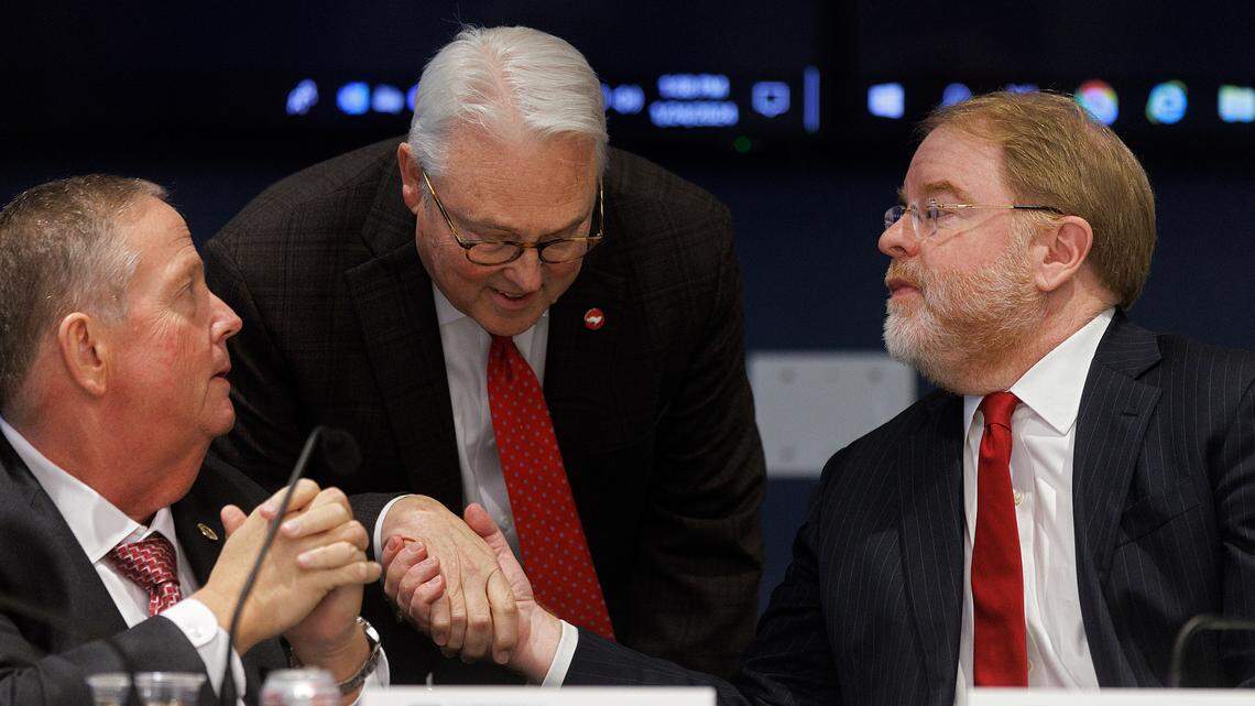 N.C. State Chancellor Randy Woodson shakes hands with UNC System President Peter Hans following a committee meeting on Wednesday, Jan. 24, 2024, in Raleigh, N.C.