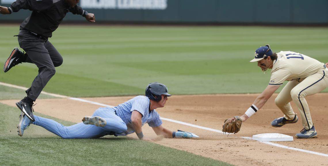North Carolina's Cooper Nicholson (1) slides past third base as Georgia Tech's Ryan Zuckerman (11) heads to tag him in the second inning during Georgia Tech’s 5-2 victory over UNC at Boshamer Stadium in Chapel Hill, N.C., Sunday, April 19, 2026.