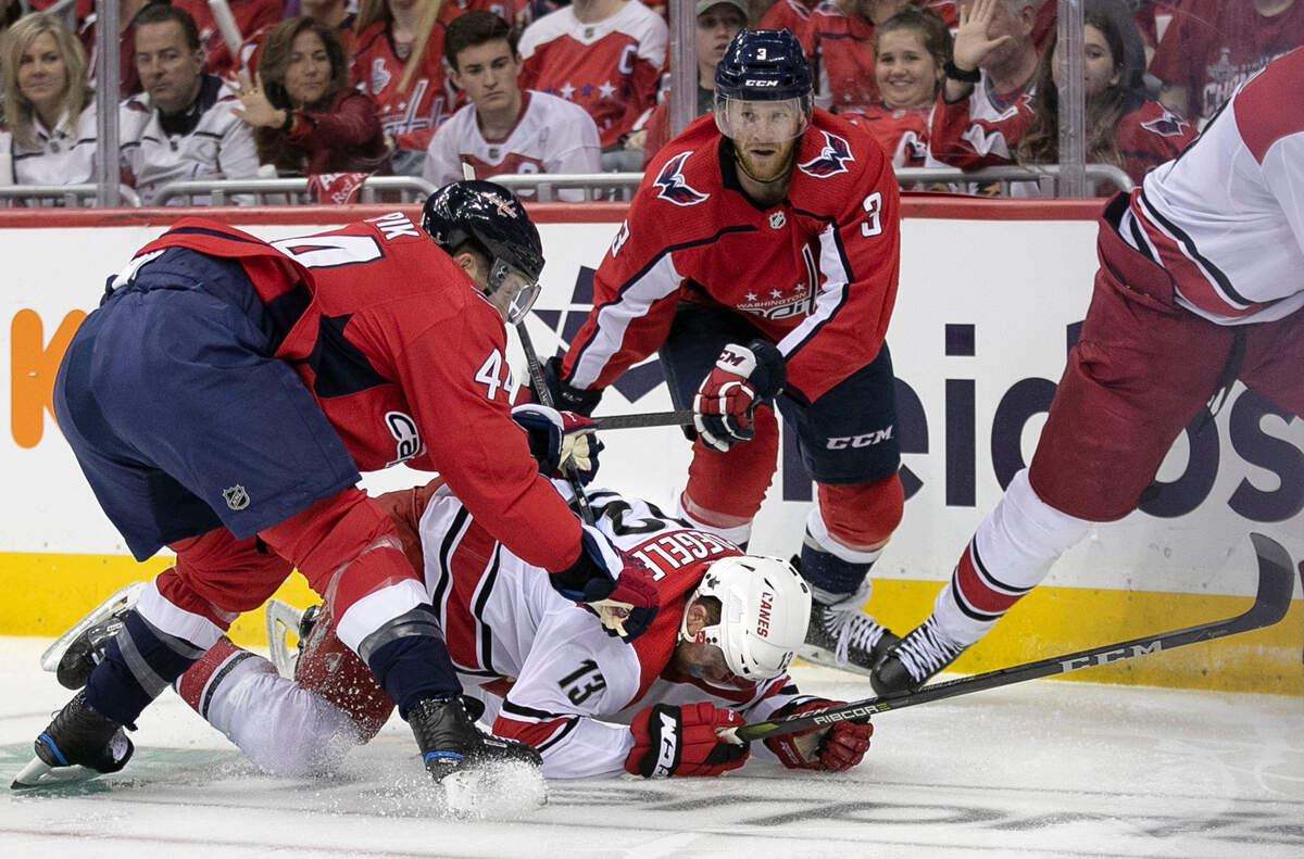 Washington Capitals’ Brooks Orpik (44) checks Carolina Hurricanes’ Warren Foegele (13) to the ice during the first period during game five of their first round Stanley Cup series game on Saturday, April 20, 2018 at Capital One Arena in Washington, D.C.