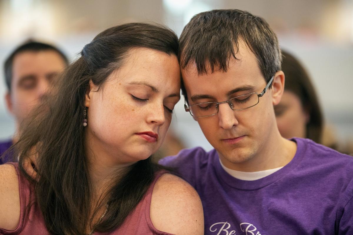 Emily and Andy Neill bow in prayer during the funeral service for their five-year-old daughter Avery Neill who died on Mother’s Day, May 13, 2018, of an incurable brain tumor known as DIPG, on Thursday, May 17, 2018, at Bayleaf Baptist Church in Raleigh, NC.