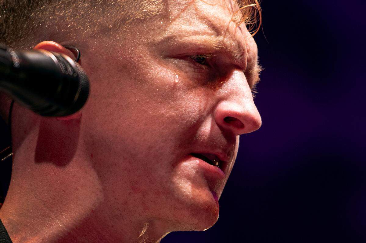 Beads of sweat roll down the face of Tyler Childers as he plays to a sold-out crowd at Raleigh, N.C.’s Red Hat Amphitheater Sunday night, Aug. 13, 2023.
