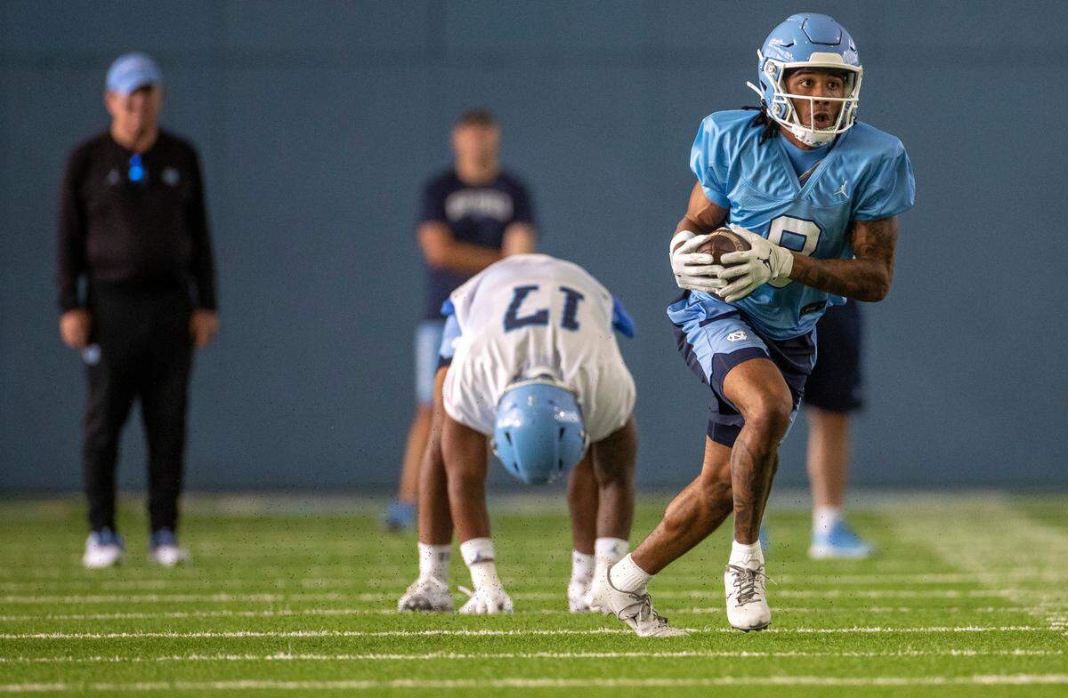 North Carolina wide receiver Kobe Paysour (8) breaks away from freshman linebacker Amare Campbell (17), after a reception from quarterback Duke Maye on Wednesday, August 2, 2023 in Chapel Hill, N.C.