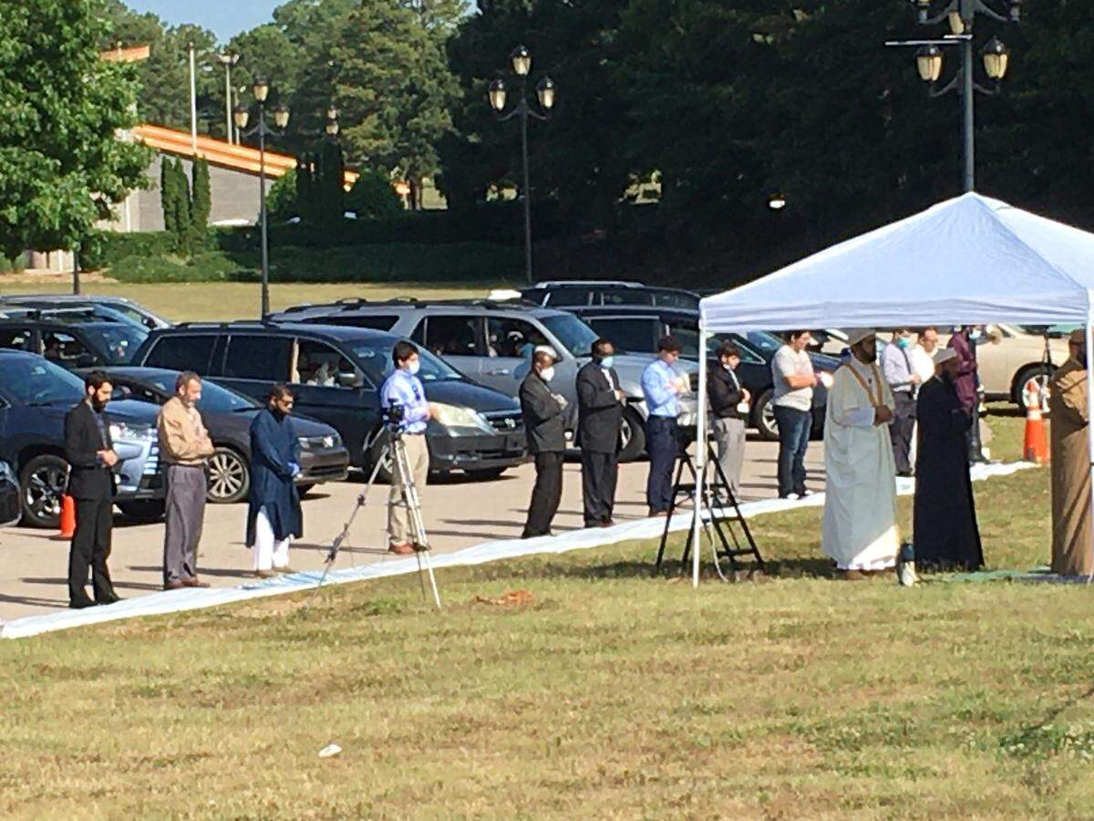 A celebration Sunday, May 24, 2020, in Raleigh, North Carolina, marks the end of Ramadan. The Islamic Association of Raleigh held two drive-in communal prayers at the North Carolina Fairgrounds. The celebration typically brings Muslims together shoulder-to-shoulder in mosques. The Islamic Association of Raleigh adapted to keep worshipers at safe distances from one another, to keep the coronavirus from spreading.