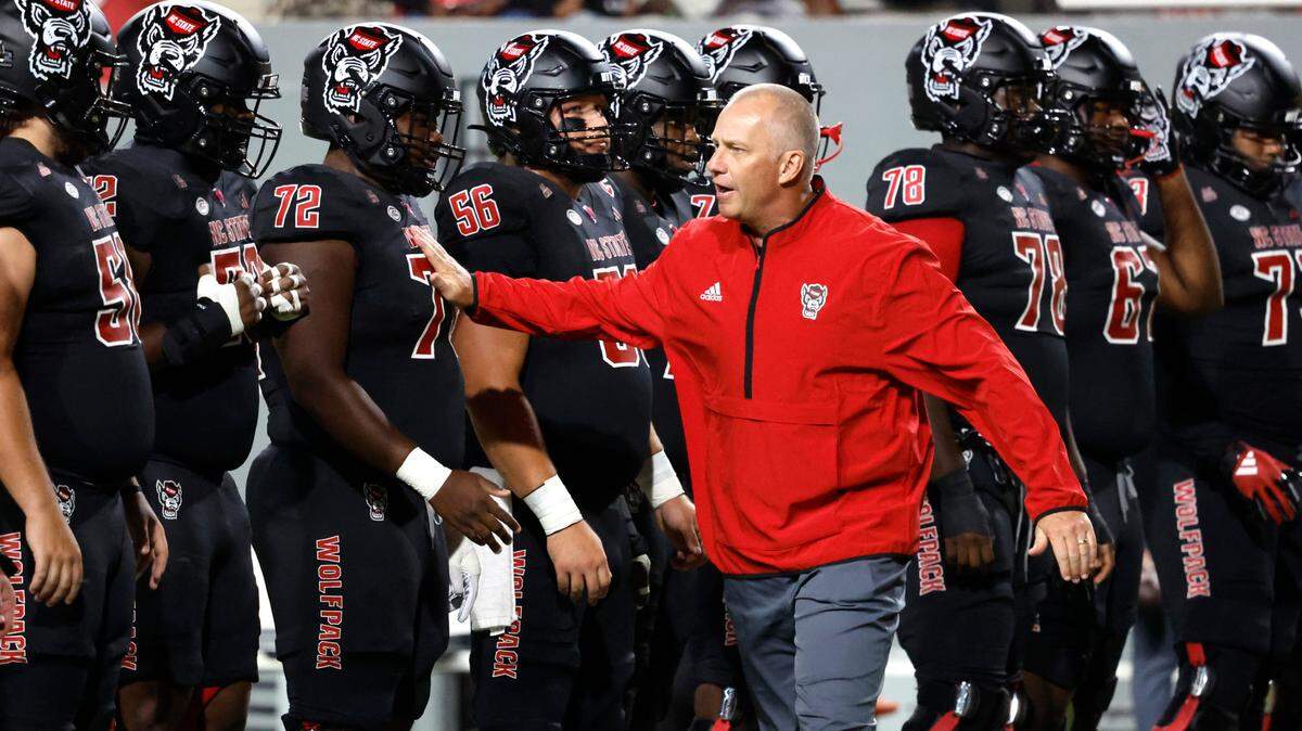 N.C. State head coach Dave Doeren pumps up the team before N.C. State’s game against Syracuse at Carter-Finley Stadium in Raleigh, N.C., Saturday, Oct. 12, 2024.