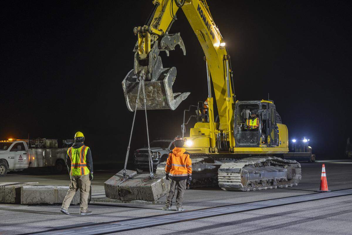 Eight minutes after the runway was closed, Hi-Way Paving’s excavator began pulling up chunks of concrete.