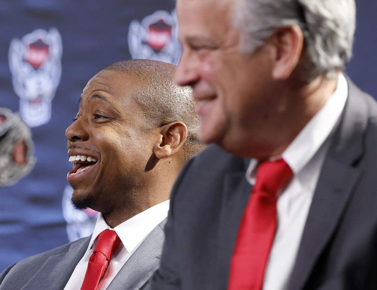 New N.C. State head men’s basketball coach Justin Gainey laughs while sitting next to  Athletic Director Boo Corrigan during press conference at the Lenovo Center in Raleigh where Gainey was officially introduced as the new coach Wednesday, April 1, 2026.