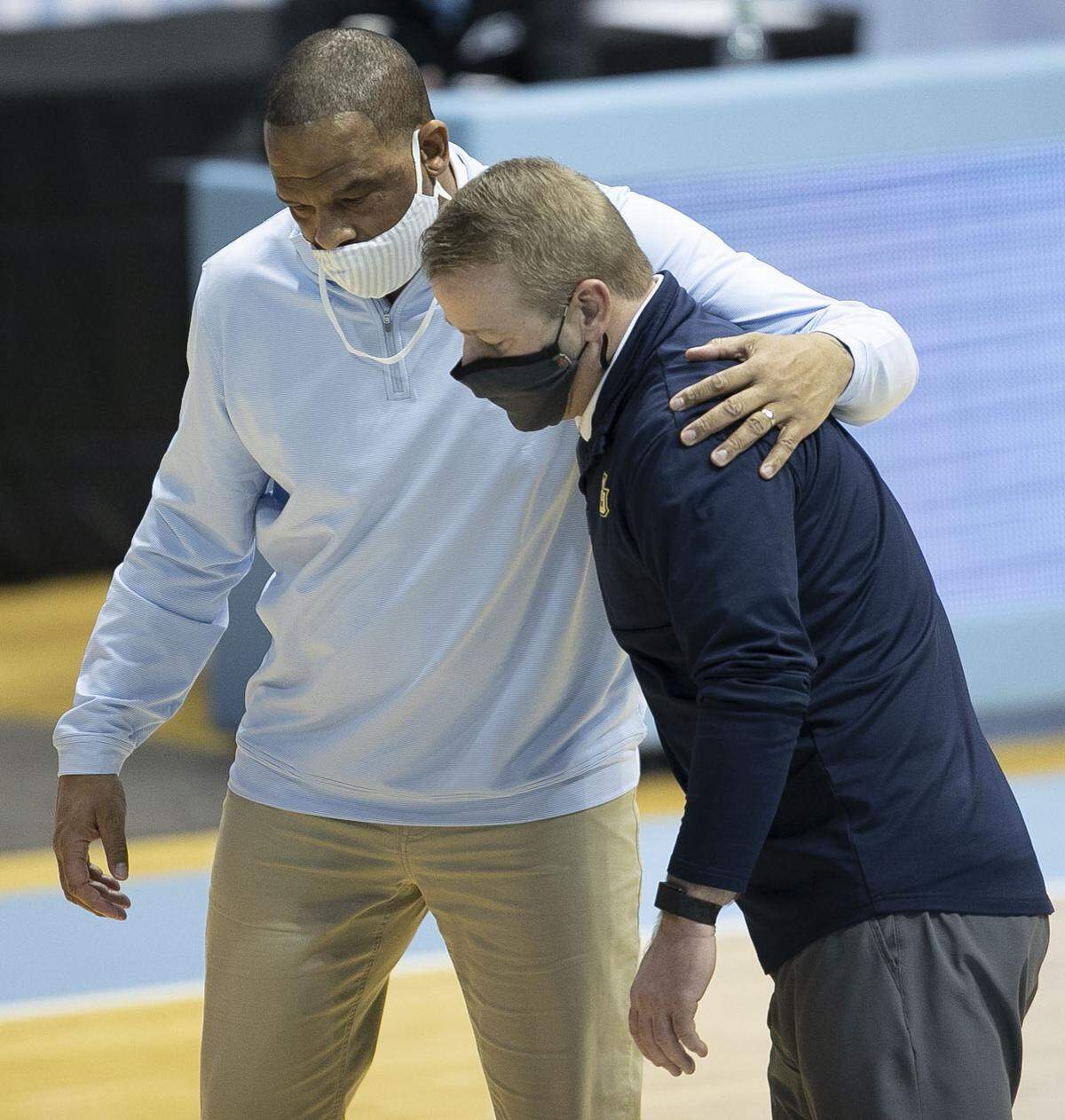 North Carolina assistant coach Hubert Davis embraces Marquette coach Steve Wojciechowski following the Tar Heels’ 83-70 loss on Wednesday, February 24, 2021 at the Smith Center in Chapel Hill, N.C.