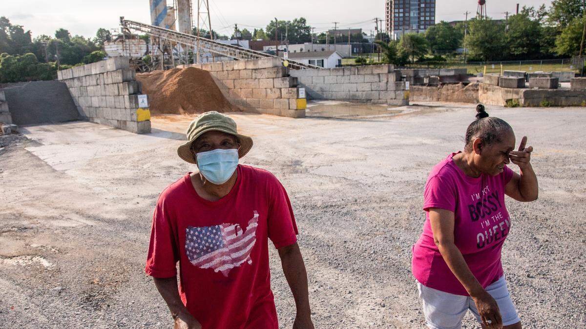 Johnny and Denise Horne walk near an Innospec chemical factory and a concrete plant in High Point’s Southside neighborhood . The Hornes’ house was among 70 on the south side where UNC-Greensboro researchers sampled the drinking water in 2017. It’s one of 29 homes where tests detected chromium levels exceeding the EPA’s drinking water standards.