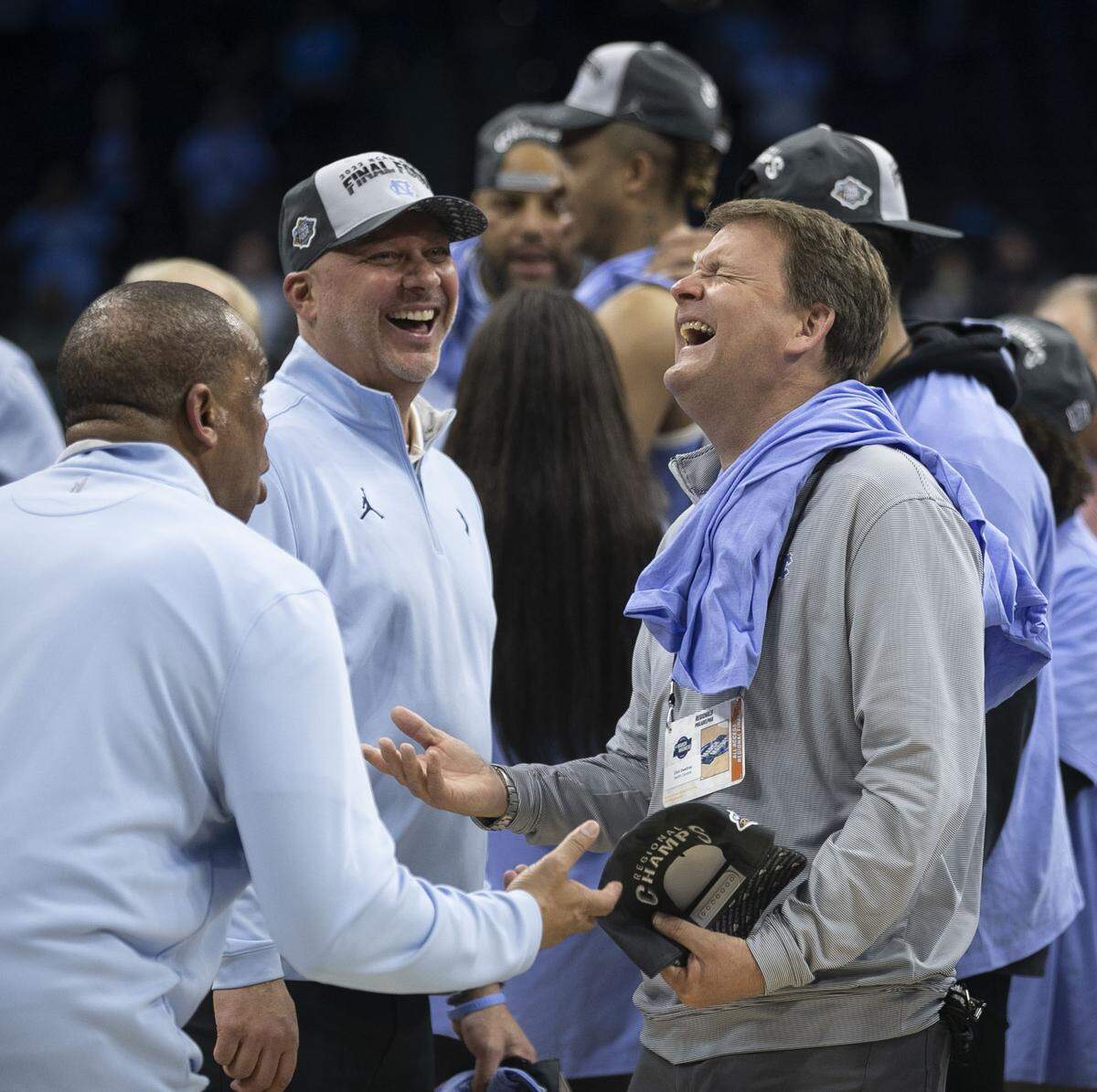 North Carolina senior associate athletic director Clint Gwaltney, laughs with head coach Hubert Davis following the Tar Heels’ victory in the NCAA East Regional final on Sunday, March 27, 2022 at Wells Fargo Center in Philadelphia, Pa.