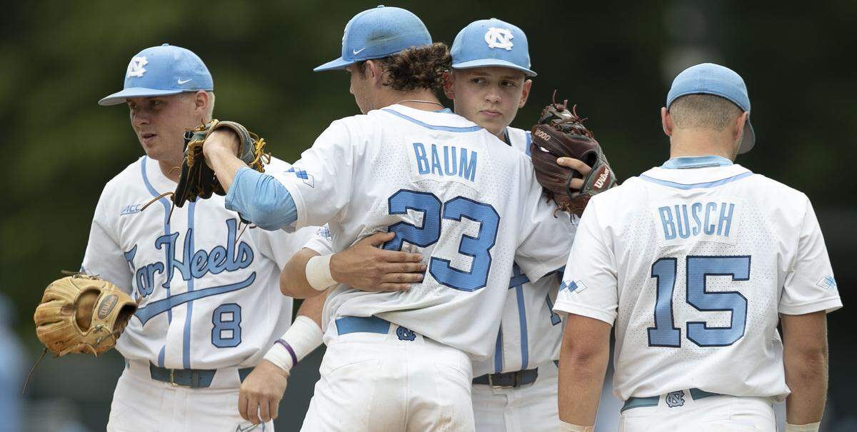 North Carolina’s Danny Serretti (1) embraces starting pitcher Tyler Baum (23) after he completed 6.1 innings against Auburn during the NCAA Super Regional on Saturday, June 8, 2019 at Boshamer Stadium in Chapel Hill, N.C.