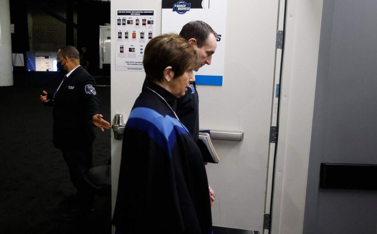 Duke head coach Mike Krzyzewski and his wife Mickie enter the locker room area after after arriving at the Chase Center before Dukes game against Arkansas in the NCAA Tournament West Regional finals in San Francisco, Calif., Saturday, March 26, 2022.
