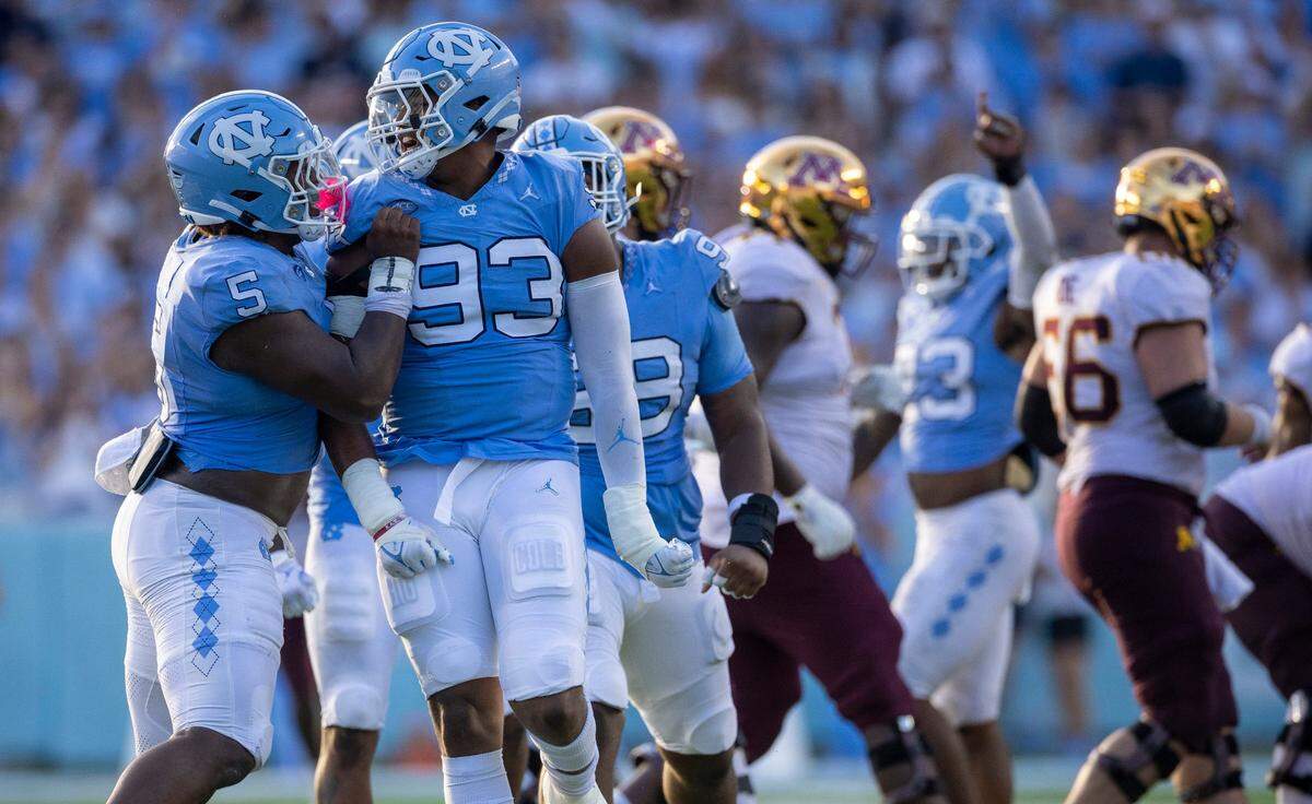 North Carolina’s Jahvaree Ritzie (5) celebrates with Jacolbe Cowan (93) after Cowan’s sack of Minnesota quarterback Athan Kaliakmanis (8) in the fourth quarter on Saturday, September 16, 2023 at Kenan Stadium in Chapel Hill N.C.