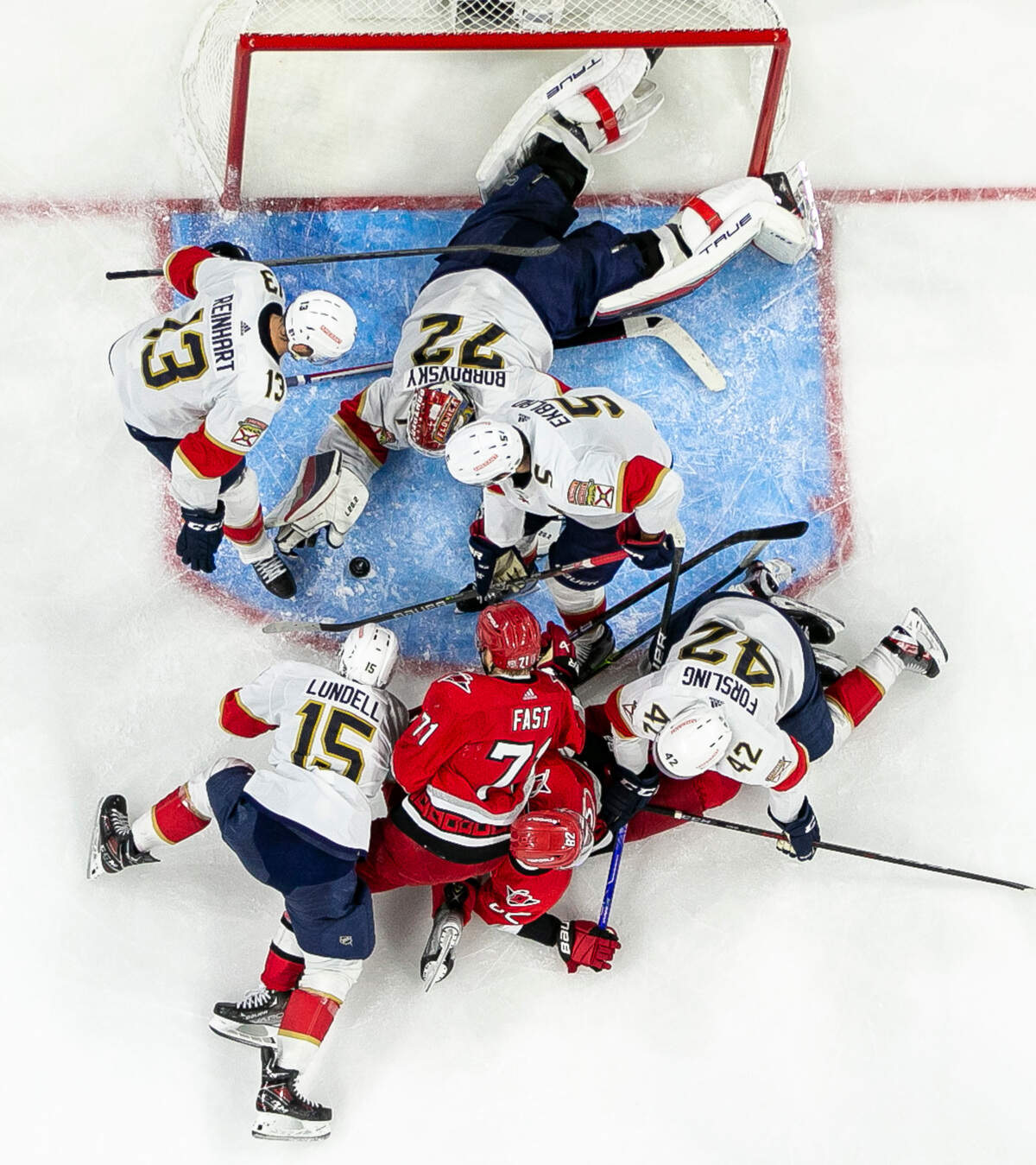 Florida Panthers goalie Sergei Bobrovsky (72) gets some help from Sam Reinhart (13) Aaron Ekblad (5) as they prevent the Carolina Hurricanes Jesper Fast (71) and Jesperi Kotkaniemi (82) from scoring in the first overtime period during Game 1 of the Eastern Conference Finals on Friday, May 19, 2023 at PNC Arena in Raleigh, N.C.