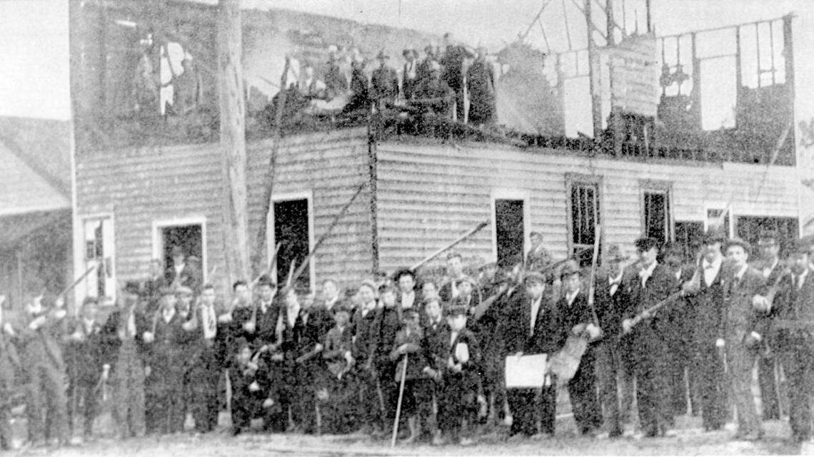 Members of a white vigilante mob pose for a photograph after burning Wilmington, N.C.’s black-readership newspaper, The Daily Record, on Nov. 10, 1898.
