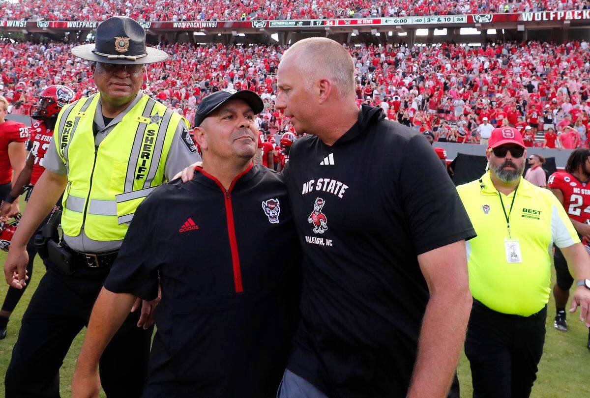 N.C. State head coach Dave Doeren celebrates with defensive coordinator Tony Gibson after N.C. State’s 24-17 victory over Northern Illinois at Carter-Finley Stadium in Raleigh, N.C., Saturday, Sept. 28, 2024.