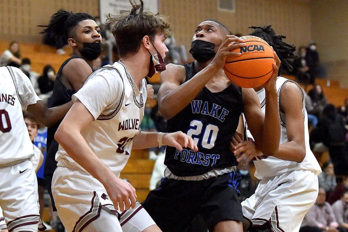 Wake Forest’s Chase Spann (20) looks to shoot against Wakefield’s Ayden Gwynn (32) late in the second half.The Wake Forest Cougars and the Wakefield Wolverines met in a conference basketball game in Raleigh, NC on February 4, 2022.