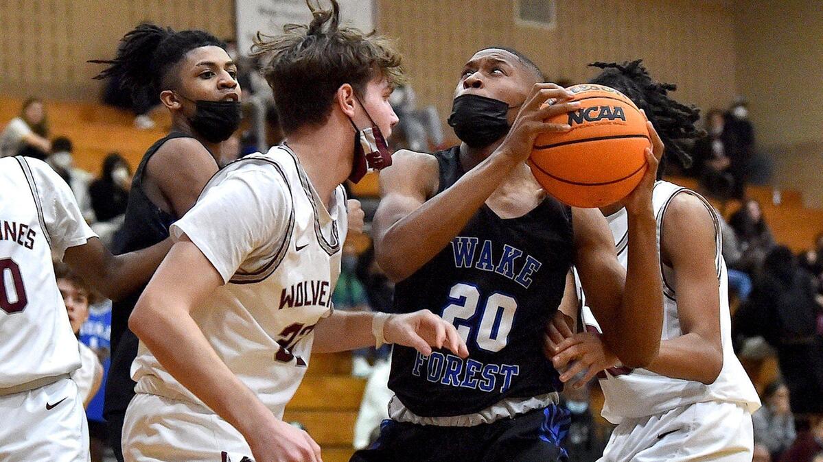 Wake Forest’s Chase Spann (20) looks to shoot against Wakefield’s Ayden Gwynn (32) late in the second half.The Wake Forest Cougars and the Wakefield Wolverines met in a conference basketball game in Raleigh, NC on February 4, 2022.