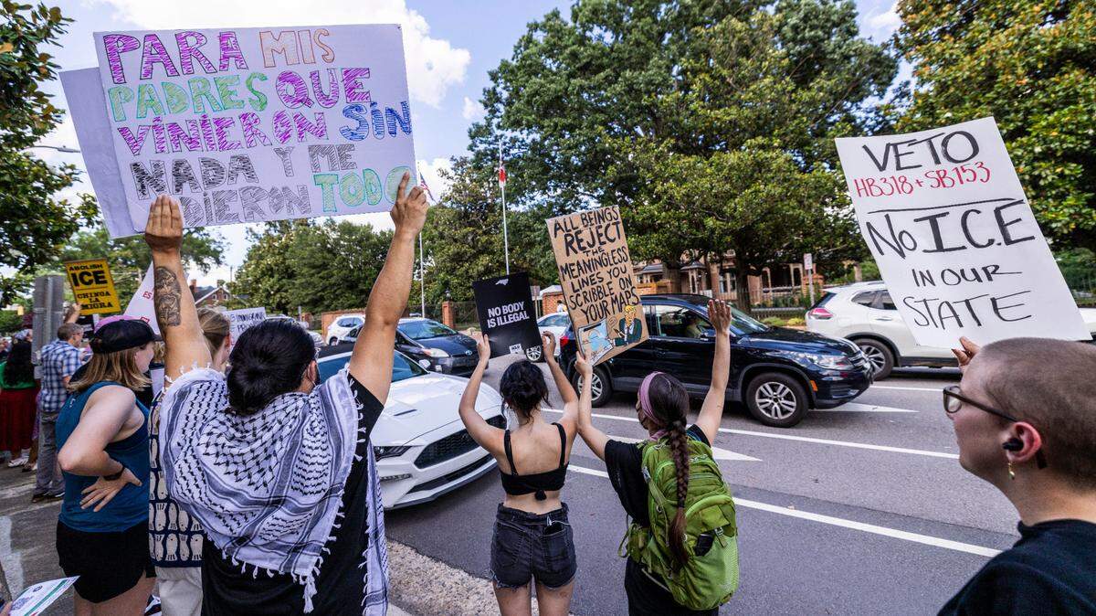 More than 100 demonstrators rallied outside the Executive Mansion in downtown Raleigh on Wednesday, June 18, 2025, urging Gov. Josh Stein to veto two GOP-backed bills that would expand state and local law enforcement cooperation with U.S. Immigration and Customs Enforcement.
