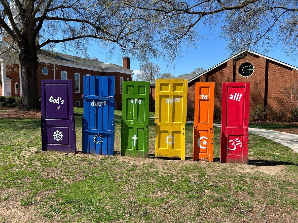 What would Elon Musk say about the diversity goals expressed in this “God’s doors are open to all” installation outside Elon Community Church?