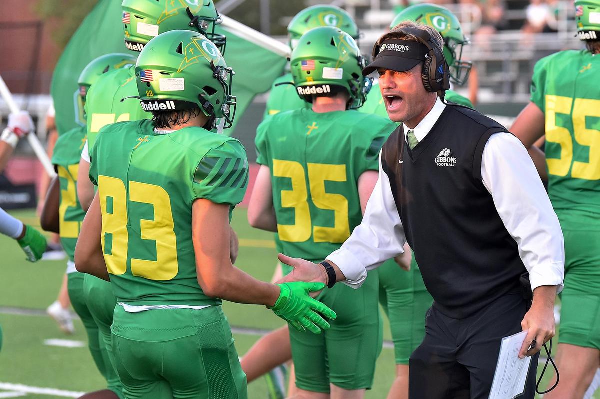 Cardinal Gibbons head coach Steven Wright congratulates Grant Cromwell (83) before the start of their game with Richmond County. The Cardinal Gibbons Crusaders and the Richmond Raiders met in a football game in Raleigh, N.C. on September 2, 2022.