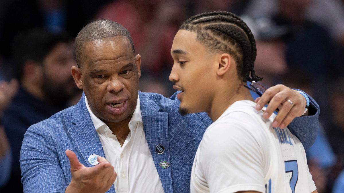 North Carolina coach Hubert Davis talks with Seth Trimble (7) as he comes out the game in the closing minutes of play against Wagner on Thursday, March 21, 2024 during the NCAA Tournament at Spectrum Center in Charlotte, N.C.