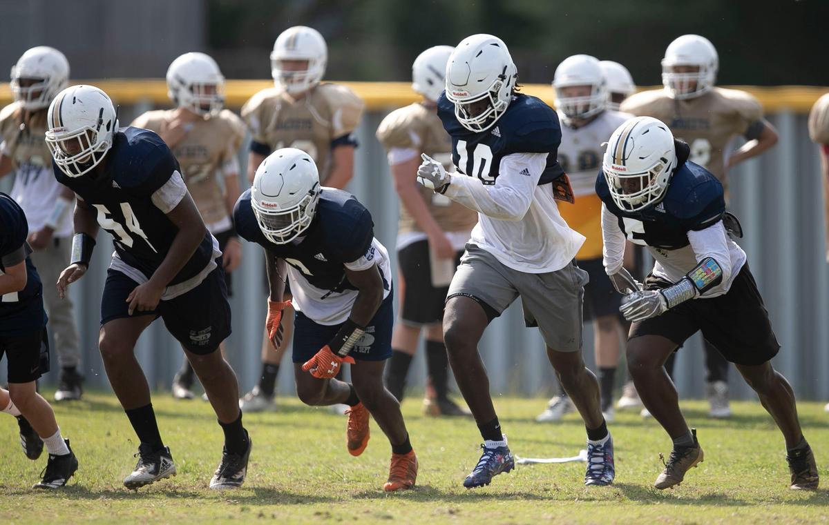 Lee County’s Desmond Evans (10) runs sprints with his teammates during practice on Saturday, August 3, 2019 at Lee County High School in Sanford, N.C.