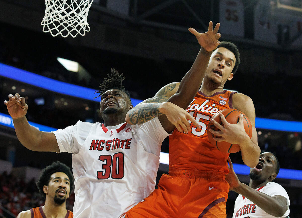 Virginia Tech’s Lynn Kidd pulls down a rebound away from N.C. State’s DJ Burns Jr. during the second half of the Wolfpack’s 84-78 loss on Saturday, Jan. 20, 2024, at PNC Arena in Raleigh, N.C.