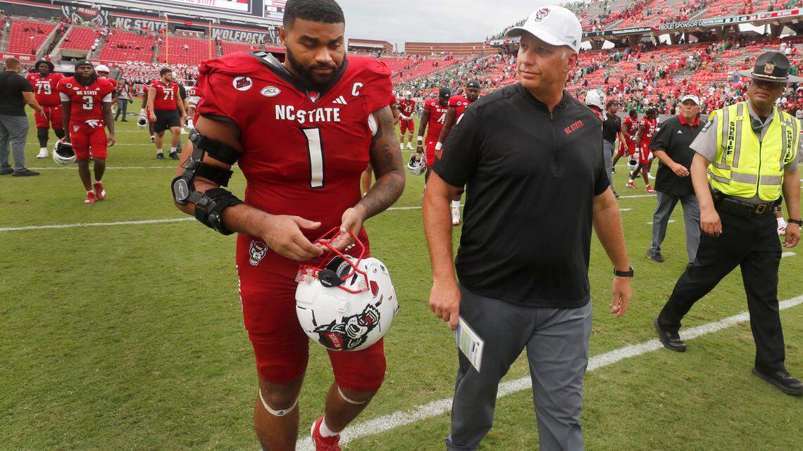 N.C. State head coach Dave Doeren walks off the field with defensive tackle Davin Vann (1) after Notre Dame’s 45-24 victory over N.C. State at Carter-Finley Stadium in Raleigh, N.C., Saturday, Sept. 9, 2023.