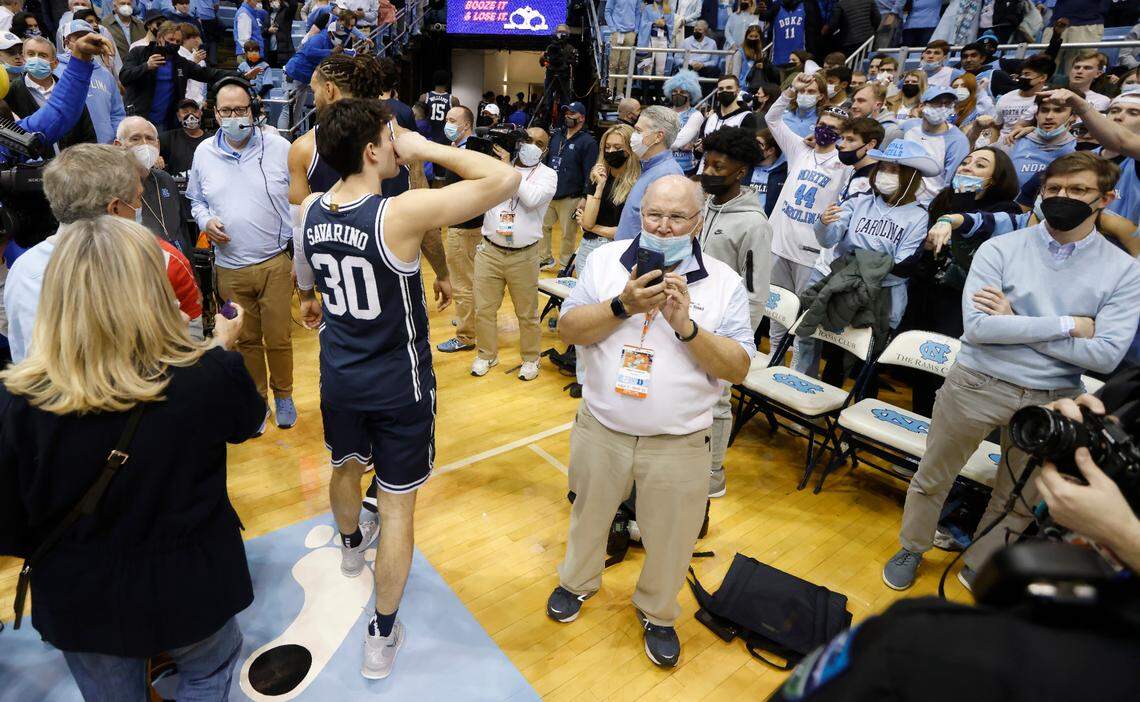 Duke’s Michael Savarino (30) gestures that he is crying as North Carolina fans heckle him as he walks off the court after Duke’s 87-67 victory over UNC at the Smith Center in Chapel Hill, N.C., Saturday, Feb. 5, 2022.