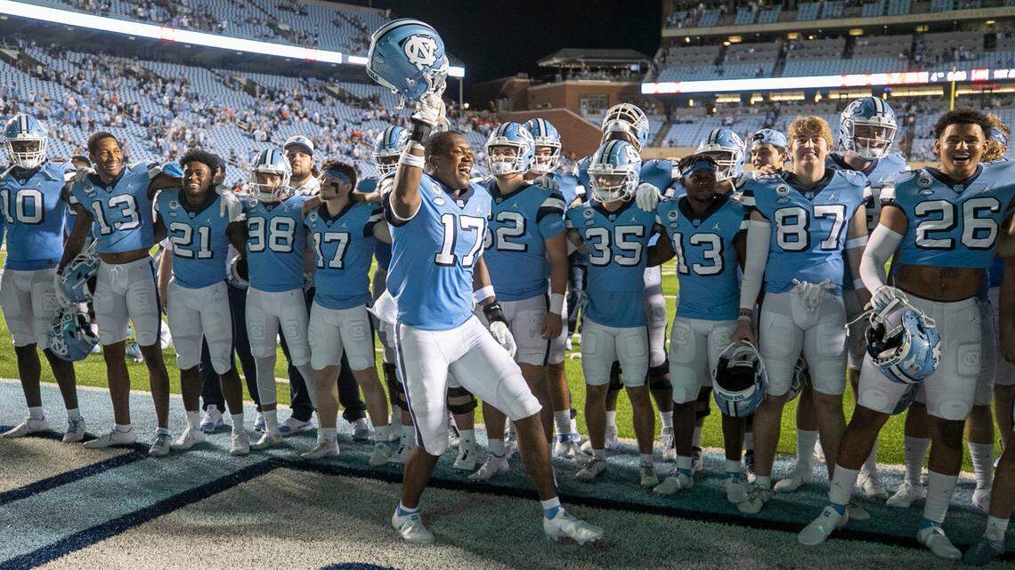 North Carolina’s Chris Collins (17) celebrates the Tar Heels’ 59-39 victory over Virginia with his teammates on Saturday, September 18, 2021 at Kenan Stadium in Chapel Hill, N.C.