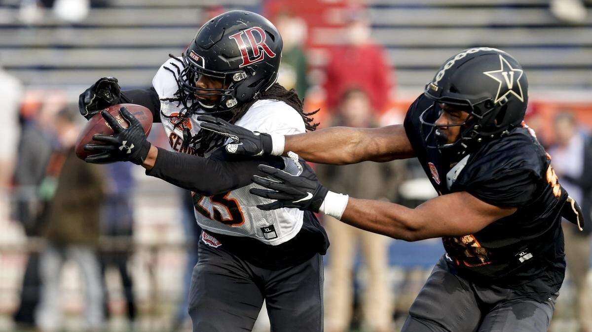 FILE - In this Jan. 22, 2020, file photo, Lenoir Rhyne’s Kyle Dugger, left, intercepts a pass intended for Vanderbilt’s Jared Pinkney as the South squad runs drills during practice for the Senior Bowl in Mobile, Ala. Dugger made Hickory, North Carolina, a must stop for NFL scouts last fall. (AP Photo/Butch Dill, File)