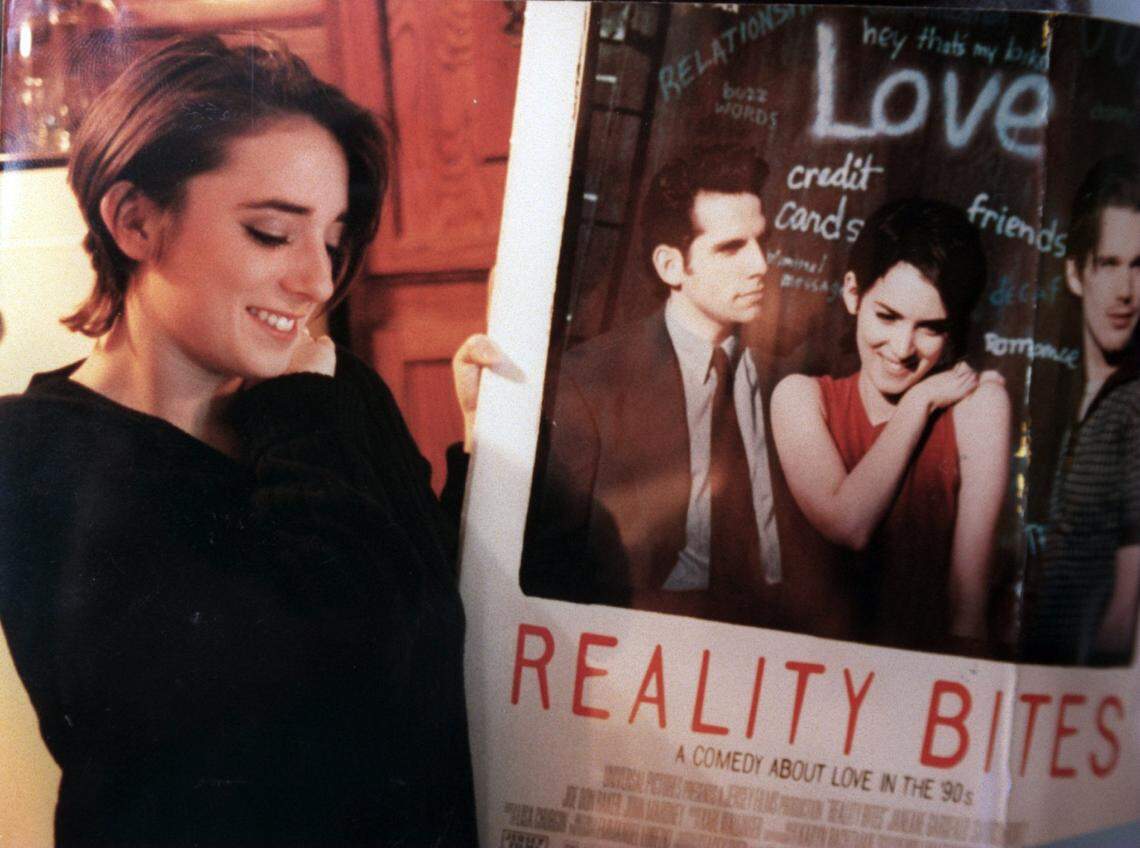 Beth Allen Vinson poses with a movie poster for “Reality Bites” starring Winona Ryder.