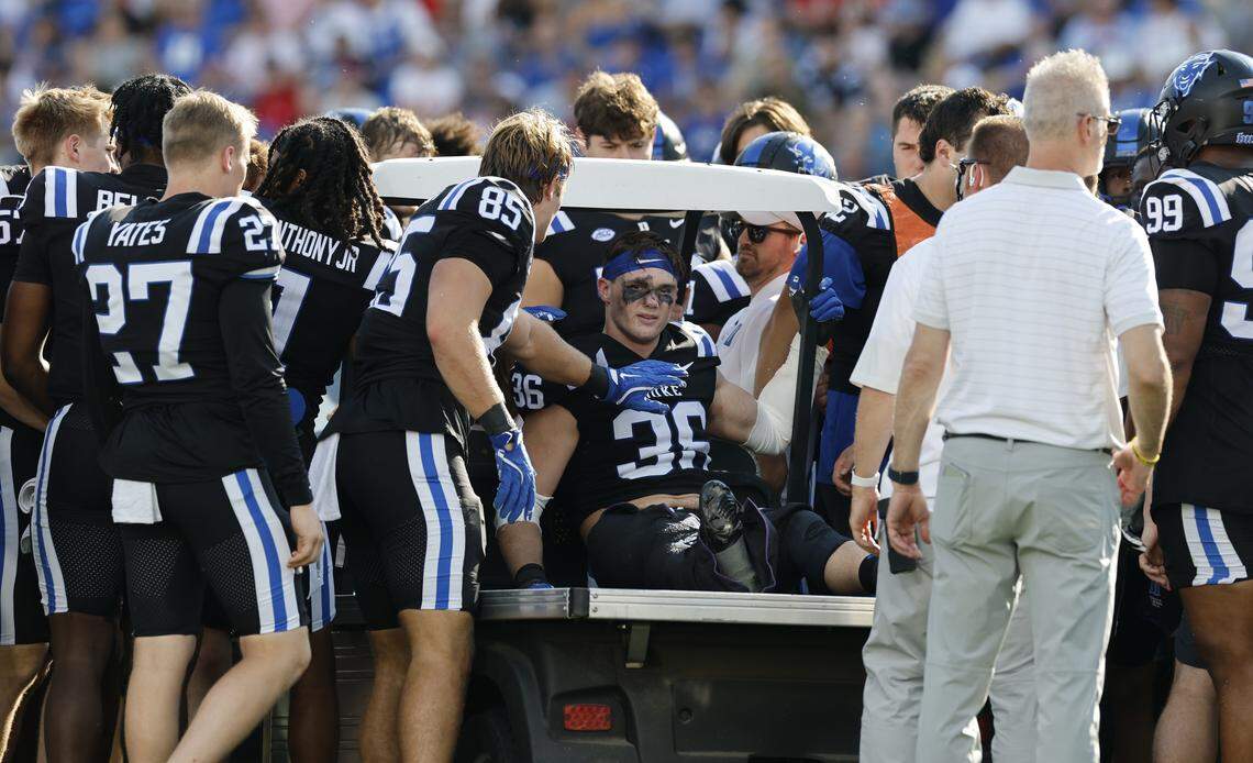 Duke players gather around Nick Morris Jr. (36) before he is carted off the field after being injured during N.C. State’s game against Duke at Wallace Wade Stadium in Durham, N.C., Sat. Sept. 20, 2025