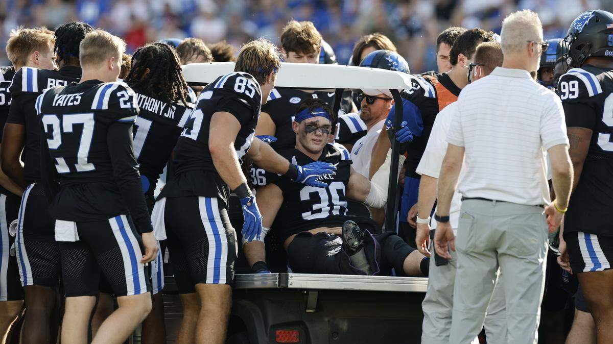 Duke players gather around Nick Morris Jr. (36) before he is carted off the field after being injured during N.C. State’s game against Duke at Wallace Wade Stadium in Durham, N.C., Sat. Sept. 20, 2025