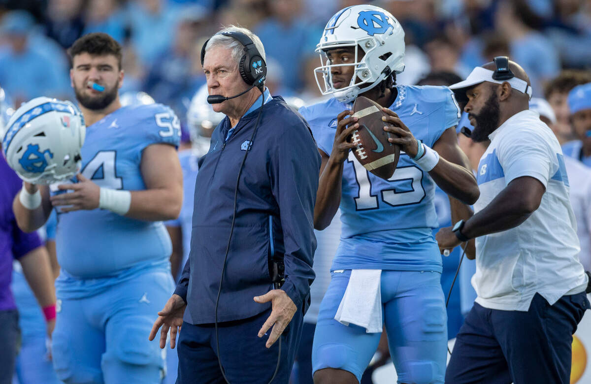 North Carolina reserve quarterback Conner Harrell (15) warms up beside coach Mack Brown, to replace Drake Maye during the fourth quarter against Syracuse on Saturday, October 7, 2023 at Kenan Stadium in Chapel Hill, N.C.