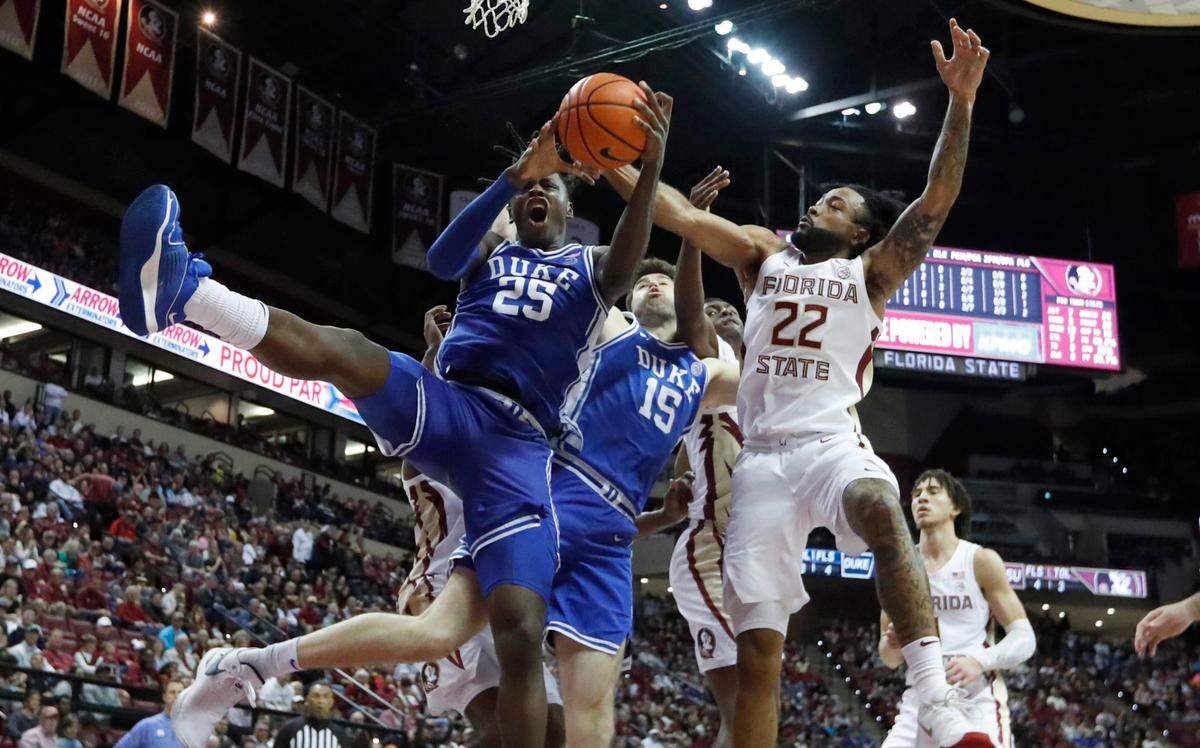 Duke’s Mark Mitchell (25) comes down with a rebound from Florida State’s Darin Green Jr. (22) during Duke’s 76-67 victory over Florida State University at the Tucker Center in Tallahassee, Fla. Sat. February 17, 2024.