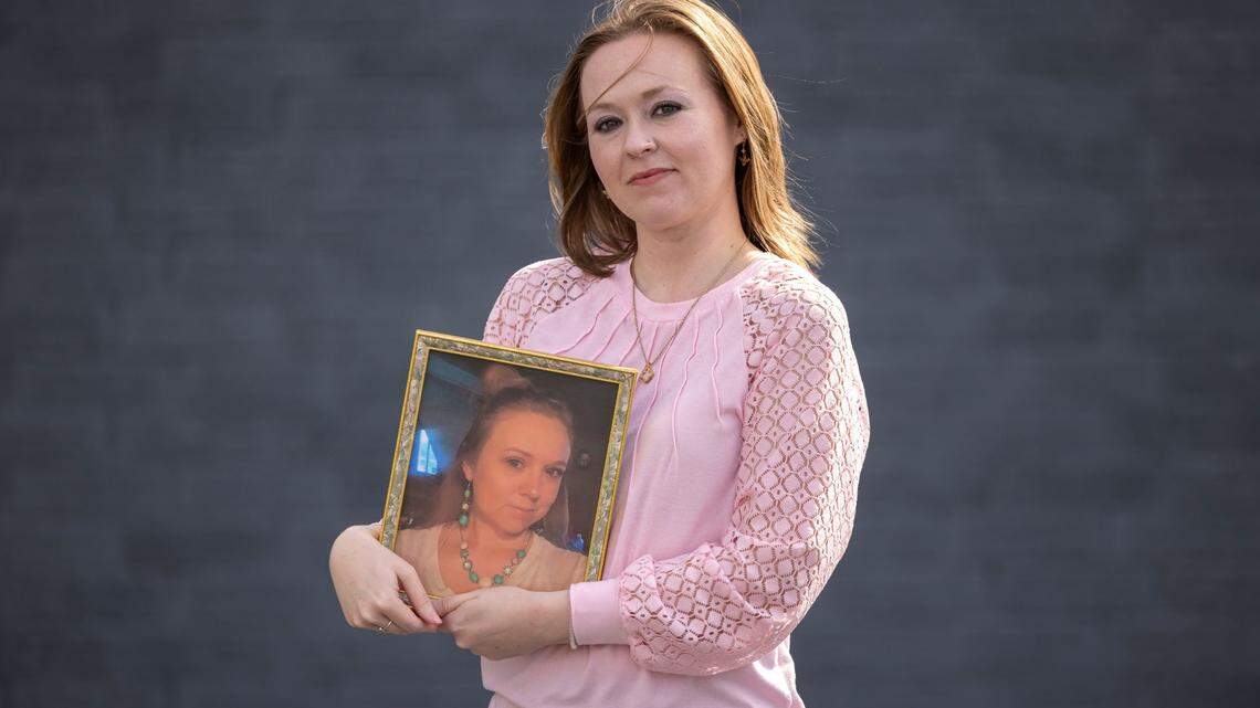 Kelly White poses for a portrait with a photograph of her missing cousin, Alena Ayers, on Sunday, March 16, 2025 in Hickory, N.C. Ayers and her husband Stephen Ayers were swept away during the historic flooding of the North Toe River in the wake of Hurricane Helene. Stephen Ayers’ remains were recovered in Tennessee, while Alena is still considered missing.