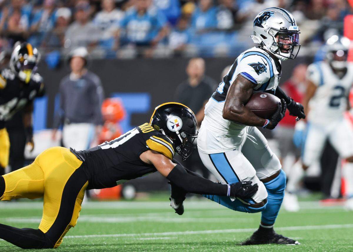 Carolina Panthers Terrace Marshall Jr., right, is tackled by Pittsburgh Steelers Tre Norwood at the Bank of America Stadium in Charlotte, N.C., on Friday, August 27, 2021.