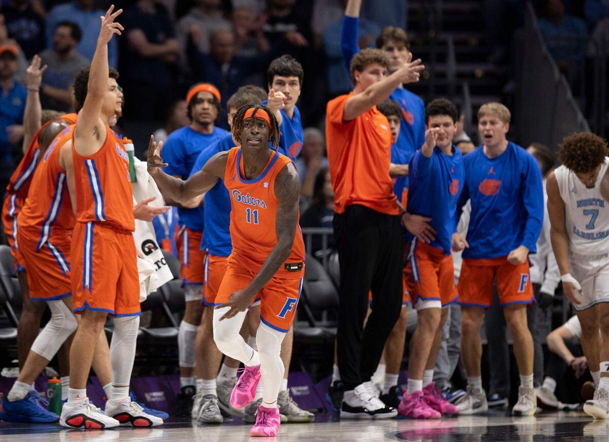 Florida’s Denzel Aberdeen (11) reacts in front of the Gators’ bench after sinking a three-point basket in the second half to take a six point lead over North Carolina during the Jumpman Invitational on Tuesday, December 17, 2024 at the Spectrum Center in Charlotte, N.C.