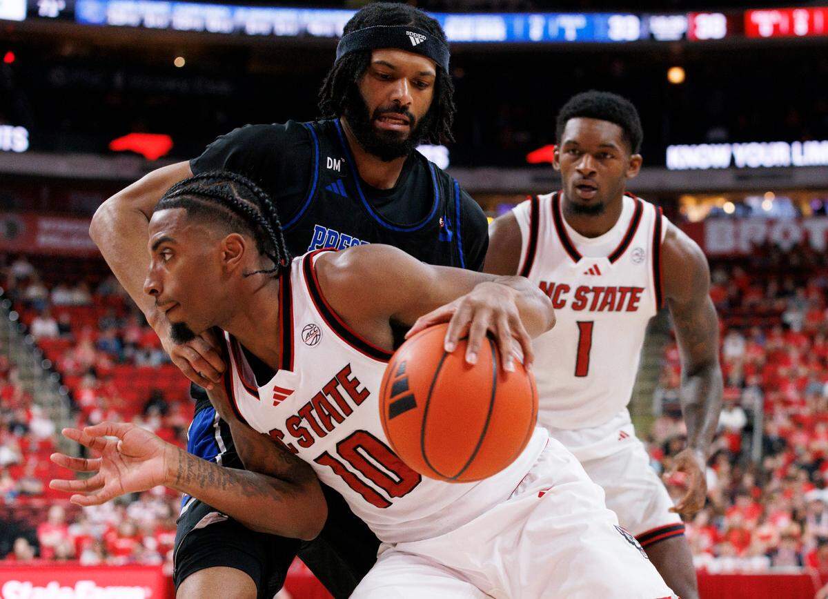 N.C. State’s Marcus Hill drives past Presbyterian’s Jamahri Harvey during the second half of the Wolfpack’s 81-72 win on Friday, Nov. 8, 2024, at Lenovo Center in Raleigh, N.C.